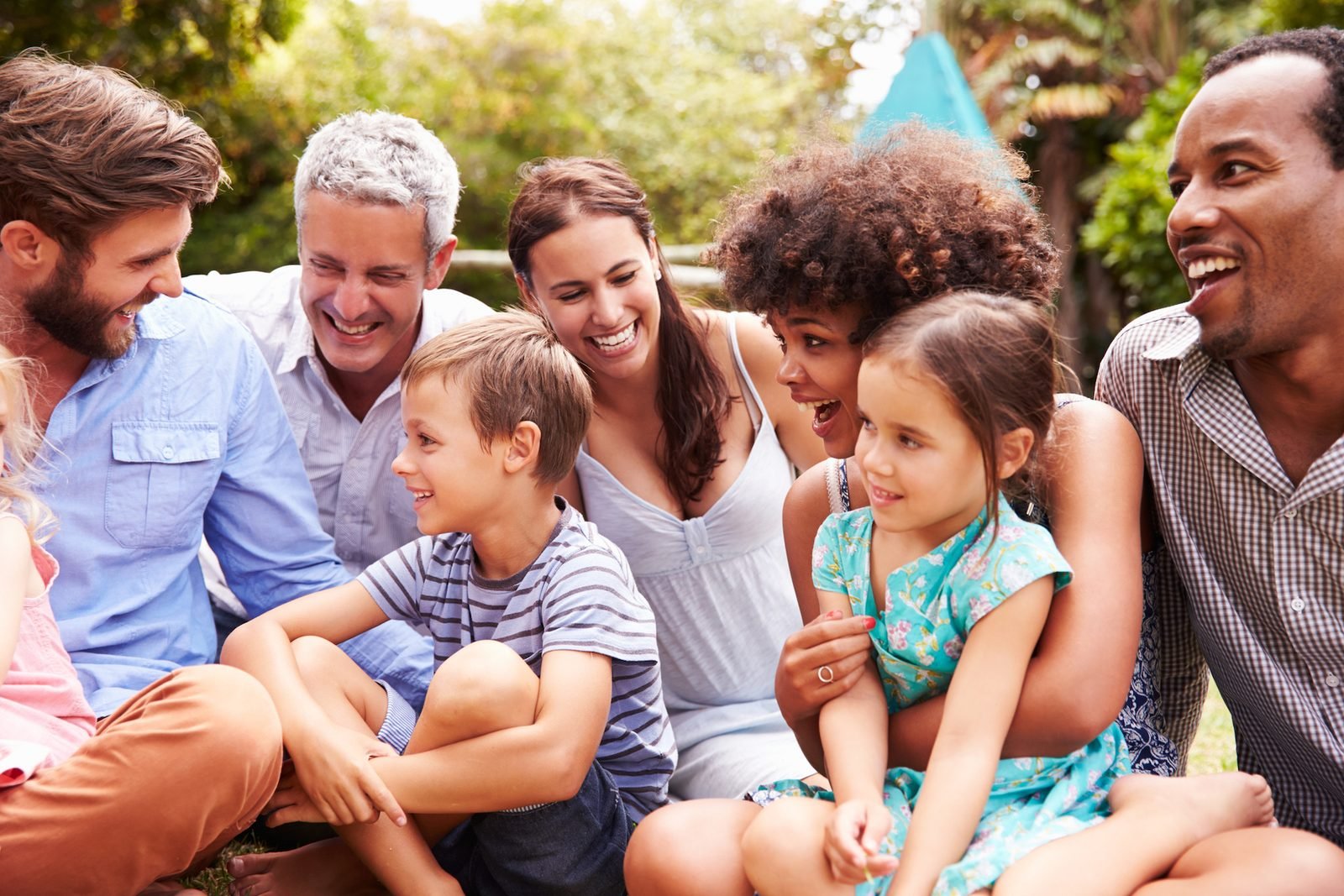 A multigenerational family laughing together outdoors